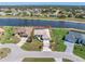 Aerial view of a beautiful home in a waterfront neighborhood with a large pool and well-manicured lawn at 26373 Madagascar, Punta Gorda, FL 33983