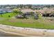 Beautiful lakefront property with a screened pool, palms, and lush landscaping at 26373 Madagascar, Punta Gorda, FL 33983