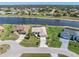Beautiful waterfront home with a tile roof, well-manicured lawn, and a long driveway at 26373 Madagascar, Punta Gorda, FL 33983
