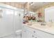 This is a traditionally decorated bathroom with a wallpapered accent wall and a white vanity at 26373 Madagascar, Punta Gorda, FL 33983