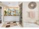 This bathroom has double sinks with granite countertops, a walk-in shower, and a soaking tub at 26373 Madagascar, Punta Gorda, FL 33983