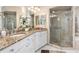 This bathroom has double sinks with granite countertops and a tiled walk-in shower at 26373 Madagascar, Punta Gorda, FL 33983