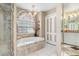 This bathroom has a soaking tub, a window, and a walk-in shower at 26373 Madagascar, Punta Gorda, FL 33983