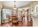 Cozy dining area with a glass table, wood chairs, and large windows, perfect for enjoying meals with a view at 26373 Madagascar, Punta Gorda, FL 33983