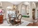 Elegant dining room with a glass table, chandelier, and large arched window creates a sophisticated ambiance at 26373 Madagascar, Punta Gorda, FL 33983