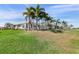 Lovely Florida home boasts multiple palm trees and a large screened in lanai overlooking the manicured lawn at 26373 Madagascar, Punta Gorda, FL 33983