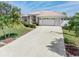This home has a concrete driveway that leads to a two-car garage and is surrounded by lush tropical landscaping at 26373 Madagascar, Punta Gorda, FL 33983