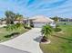 This Florida home has a well maintained lawn, a long driveway, and tropical landscaping at 26373 Madagascar, Punta Gorda, FL 33983