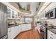 Stylish kitchen with white cabinets, granite countertops, and stainless steel appliances at 26373 Madagascar, Punta Gorda, FL 33983