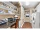 Functional laundry room with a built-in desk, shelves, and modern appliances at 26373 Madagascar, Punta Gorda, FL 33983