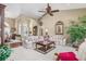 Inviting living room with an open layout, archways, comfortable seating, and a view leading to the dining area at 26373 Madagascar, Punta Gorda, FL 33983
