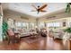 Cozy living room with hardwood floors, ample seating, and many windows with views of the lake at 26373 Madagascar, Punta Gorda, FL 33983