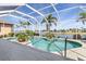 Beautiful screened-in pool area with lush landscaping and serene lake views at 26373 Madagascar, Punta Gorda, FL 33983