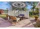 Outdoor patio area with a table, chairs, and shade umbrella in a fenced yard at 2720 Jay Pl, Sarasota, FL 34235