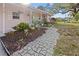 Beautiful front yard with a stone walkway leading to the charming pink home at 2720 Jay Pl, Sarasota, FL 34235