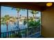 Relaxing balcony showcasing waterfront views and tropical landscaping at 3216 Purple Martin Dr # 121, Punta Gorda, FL 33950