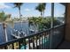 Outdoor balcony overlooking waterfront, palm trees, and boat docks at 3216 Purple Martin Dr # 121, Punta Gorda, FL 33950