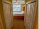 Hallway view into the bedroom showcasing closet space and bright lighting at 3216 Purple Martin Dr # 121, Punta Gorda, FL 33950
