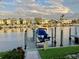 Water view showing a boat on a boat lift at a private residential dock at 3216 Purple Martin Dr # 121, Punta Gorda, FL 33950