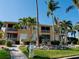 Building with a walkway and palm trees at 3216 Purple Martin Dr # 121, Punta Gorda, FL 33950