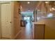 Long hallway with a view into the kitchen and a world map hanging on the wall at 3216 Purple Martin Dr # 121, Punta Gorda, FL 33950