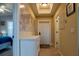 Hallway with white dresser, tile floors, and a world map on the wall at 3216 Purple Martin Dr # 121, Punta Gorda, FL 33950