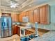 Spacious kitchen with wooden cabinets, stainless steel appliances, and granite countertops at 3216 Purple Martin Dr # 121, Punta Gorda, FL 33950