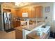 Bright kitchen featuring stainless steel appliances, light wood cabinetry, and granite countertops at 3216 Purple Martin Dr # 121, Punta Gorda, FL 33950
