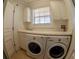 Well-lit laundry room featuring modern washer and dryer at 3216 Purple Martin Dr # 121, Punta Gorda, FL 33950