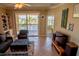 Living room with a gray sofa, tile flooring, and a sliding glass door to a balcony at 3216 Purple Martin Dr # 121, Punta Gorda, FL 33950