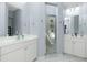 Bright bathroom featuring double sinks, walk in shower and tile floors at 3748 Albacete Cir # 38, Punta Gorda, FL 33950