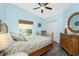 Comfortable bedroom with a bamboo bed, dresser and wood grain floors at 3748 Albacete Cir # 38, Punta Gorda, FL 33950