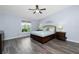 Comfortable bedroom with a ceiling fan, stylish decor and wood grain floors at 3748 Albacete Cir # 38, Punta Gorda, FL 33950