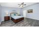 Bright bedroom with a ceiling fan, light blue walls and wood grain floors at 3748 Albacete Cir # 38, Punta Gorda, FL 33950