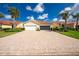 Beautiful home with a well-manicured lawn, tile roof, and large brick driveway, creating great curb appeal at 3748 Albacete Cir # 38, Punta Gorda, FL 33950