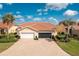 Beautiful home with a well-manicured lawn, tile roof, and large brick driveway, creating great curb appeal at 3748 Albacete Cir # 38, Punta Gorda, FL 33950