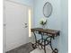 Inviting foyer with a decorative table, a patterned rug, and a stylish oval mirror at 3748 Albacete Cir # 38, Punta Gorda, FL 33950