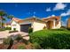 Welcoming home with a brick driveway, black garage door, and mature landscaping at 3748 Albacete Cir # 38, Punta Gorda, FL 33950