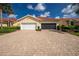 Charming home featuring a brick driveway, two-car garage, and neatly manicured landscaping in front at 3748 Albacete Cir # 38, Punta Gorda, FL 33950