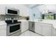 Bright kitchen featuring stainless steel appliances, mosaic backsplash, and white cabinetry at 3748 Albacete Cir # 38, Punta Gorda, FL 33950