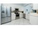 Modern kitchen featuring stainless steel appliances, white cabinetry, and sleek countertops at 3748 Albacete Cir # 38, Punta Gorda, FL 33950