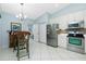 Well-lit kitchen with white cabinets, stainless steel appliances, and a breakfast nook at 3748 Albacete Cir # 38, Punta Gorda, FL 33950