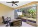 Relaxing screened lanai with comfortable wicker furniture and a view of the beautifully landscaped backyard at 3748 Albacete Cir # 38, Punta Gorda, FL 33950