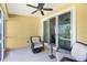 Comfortable screened lanai with wicker chairs, a ceiling fan, and sliding doors to the interior at 3748 Albacete Cir # 38, Punta Gorda, FL 33950