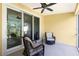 Comfortable screened lanai with wicker chairs, a ceiling fan, and sliding doors to the interior at 3748 Albacete Cir # 38, Punta Gorda, FL 33950