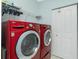 Laundry room with red washer and dryer, closet, and wire rack for storage at 3748 Albacete Cir # 38, Punta Gorda, FL 33950