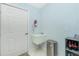 Cozy laundry room features a utility sink, a fire extinguisher, and storage shelving at 3748 Albacete Cir # 38, Punta Gorda, FL 33950