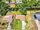 An aerial view showcasing a waterfront property with lush greenery and a private driveway at 429 Dorchester St, Port Charlotte, FL 33954