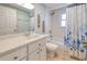 Bright bathroom featuring a tub and shower combination, stylish vanity, and nautical-themed shower curtain at 429 Dorchester St, Port Charlotte, FL 33954