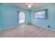 Serene blue bedroom featuring tile floors, bright windows, and ceiling fan at 429 Dorchester St, Port Charlotte, FL 33954